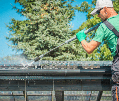 a man is cleaning the roof