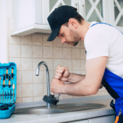 a man fixing a faucet