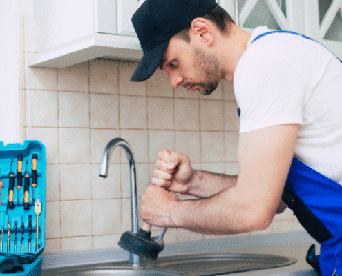 a man fixing a faucet