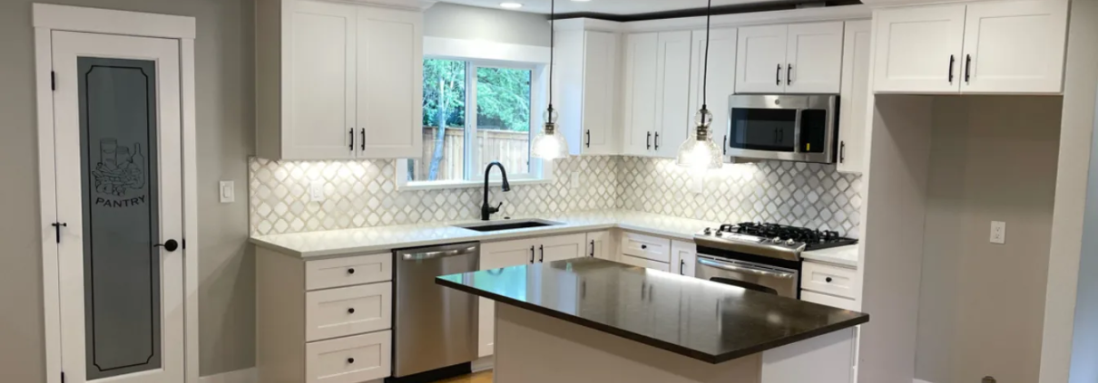 Spacious kitchen renovation with quartz countertops and custom island by Pluum Construction