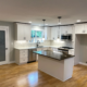 Spacious kitchen renovation with quartz countertops and custom island by Pluum Construction